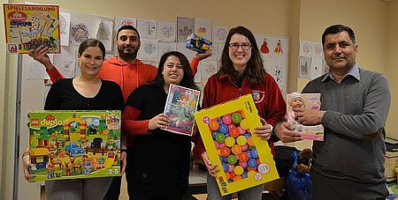 Melanie Graf (4.v.l) übergab einen Teil der gespendeten Spielzeuge an die Leiterin der DRK-Flüchtlingsunterkunft Bad Laasphe, Mireille Samaras (3.v.l) sowie an die Mitarbeiter Sara Fasolo, Ahmed Shir und Dogan Calli (v.l)